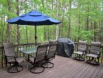 Raised deck with patio table, gas grill, and beautiful wooded views